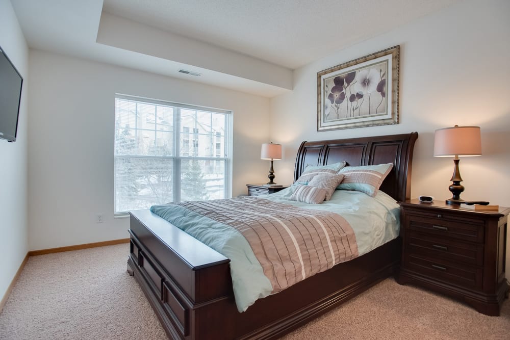 A large bedroom with abundant natural lighting at Provence Apartments in Burnsville, Minnesota