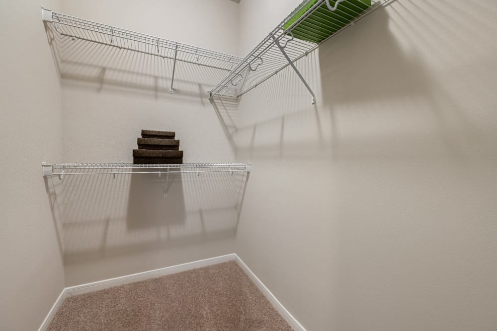 Walk in closet with built in closet organizers at Marquis at Sugar Land in Sugar Land, Texas