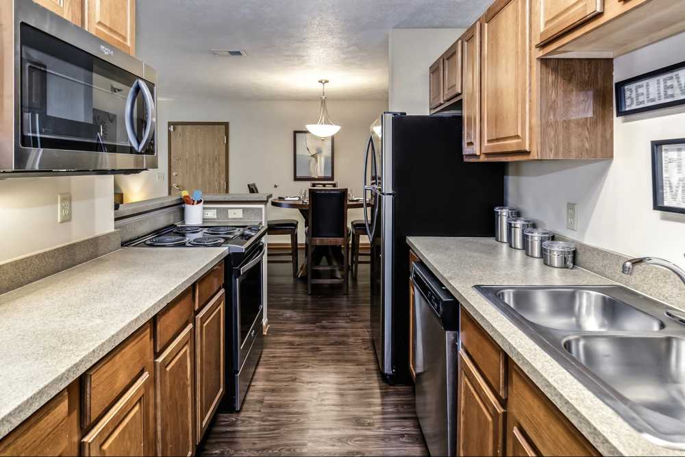 Kitchen with hardwood flooring and access to dining area at The Falgrove Apartments in Omaha, Nebraska