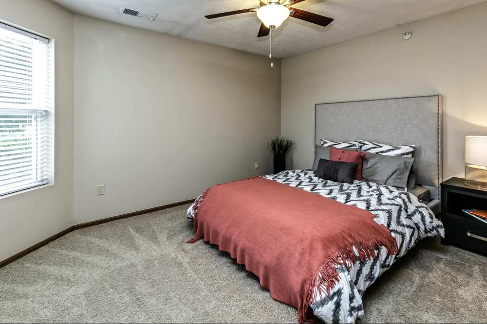 Bedroom with plush carpeting at The Falgrove Apartments in Omaha, Nebraska