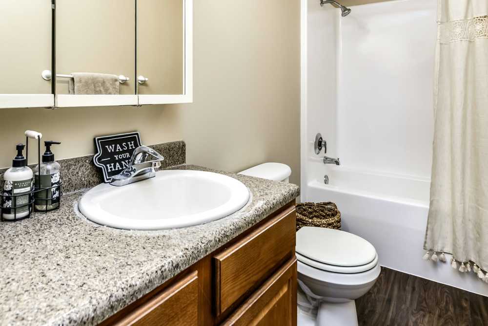 Bathroom with granite countertops at The Falgrove Apartments in Omaha, Nebraska