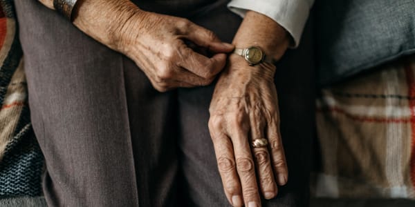 Resident adjusting her wristwatch at a WISH community