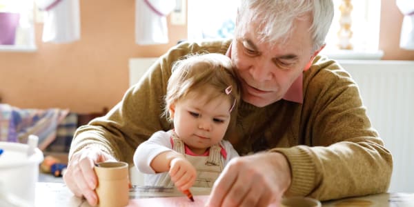 Resident doing arts and crafts with a younger family member at a WISH community