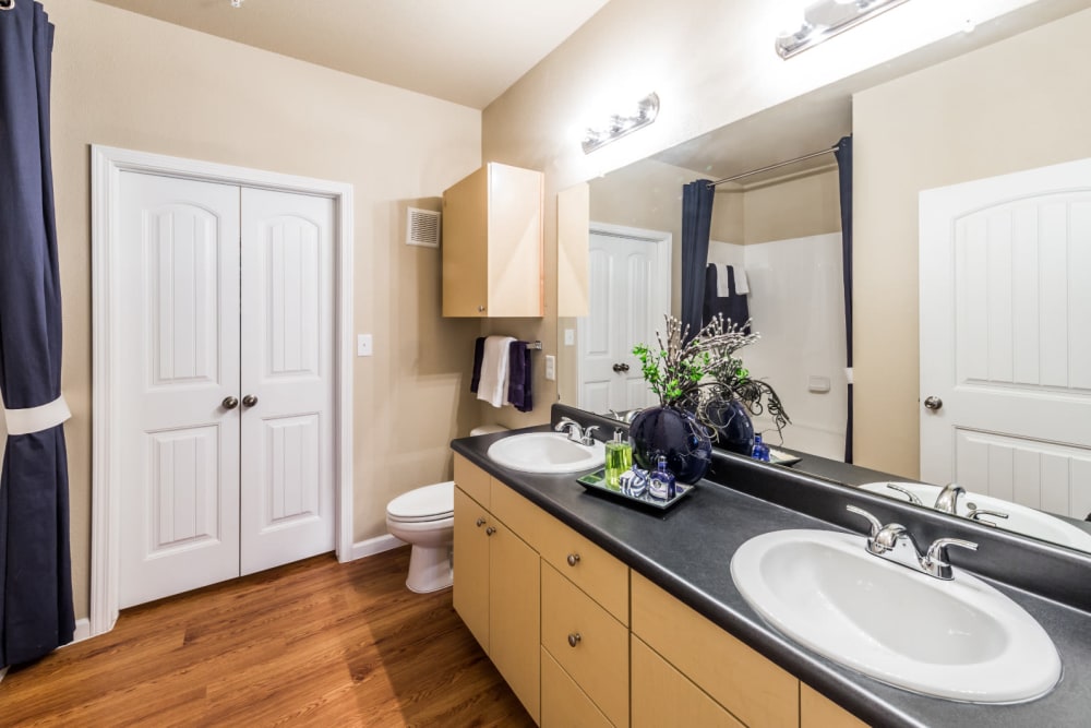 Large bathroom with double sinks and closet at Marquis at Canyon Ridge in Austin, Texas