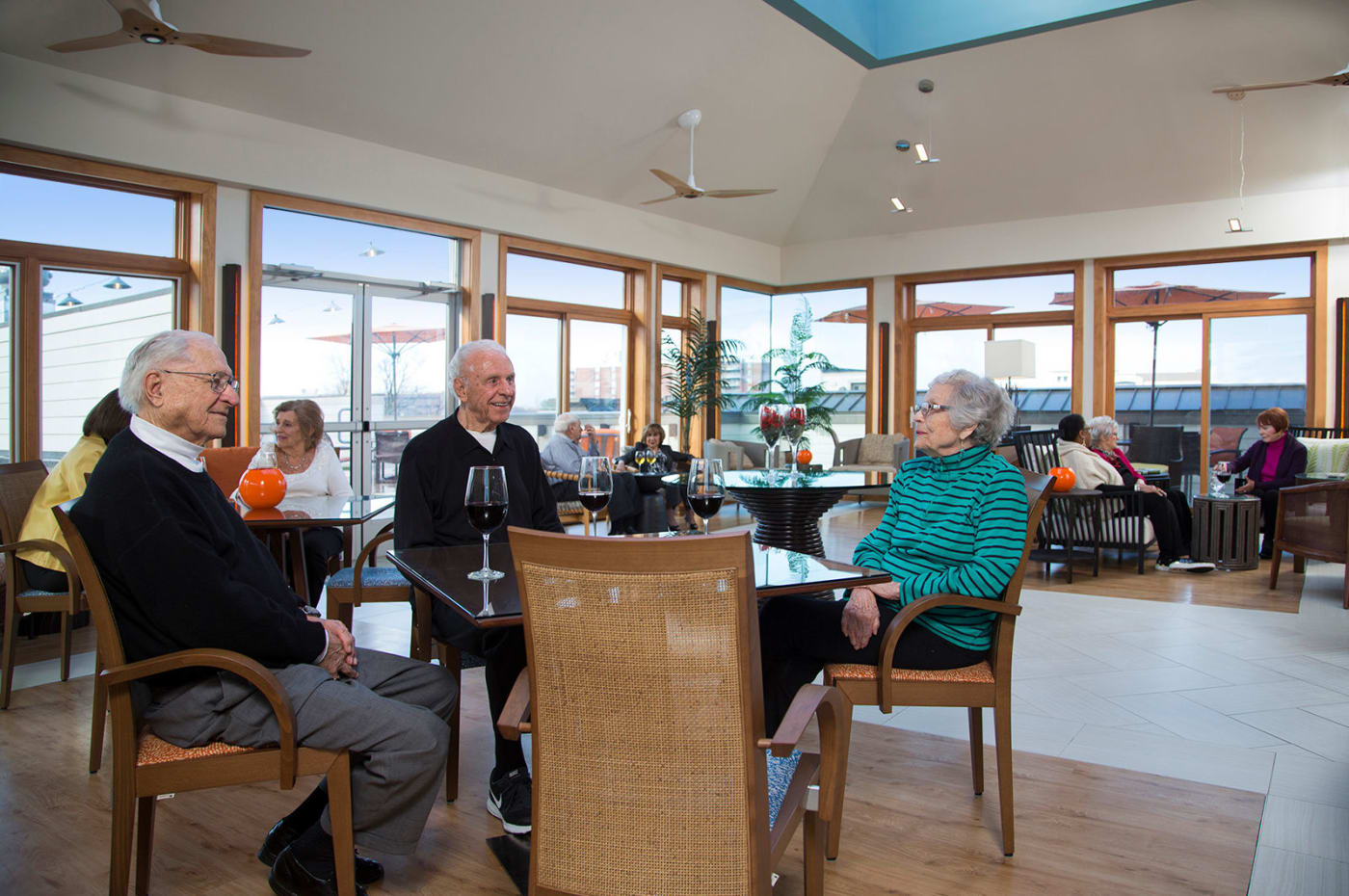 Residents enjoy dining in a naturally well lit room at All Seasons Birmingham in Birmingham, Michigan