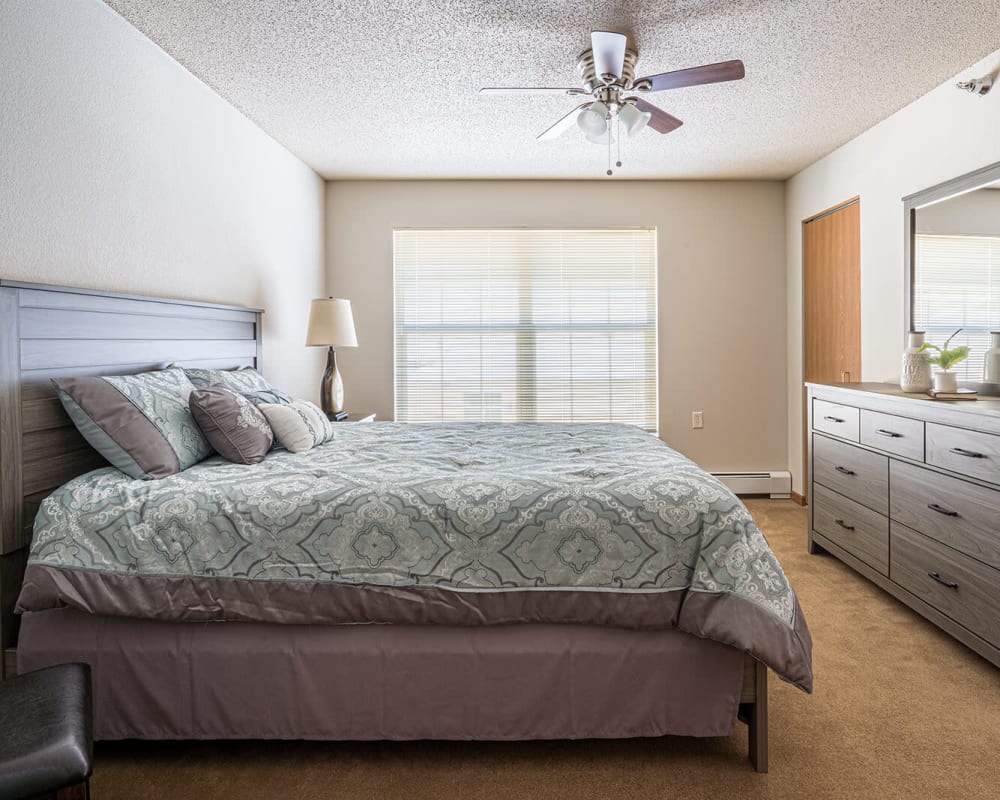Cozy apartment bedroom at Traditions of Owatonna in Owatonna, Minnesota.
