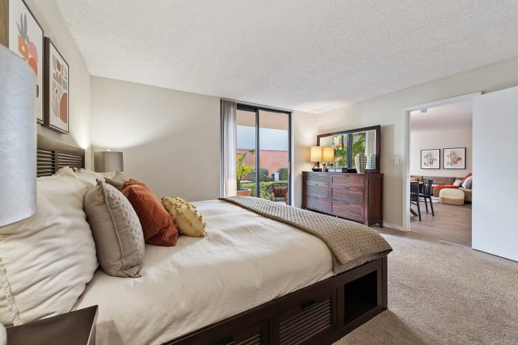 Spacious bedroom with lots of natural light at New Barn Apartments in Miami Lakes, Florida