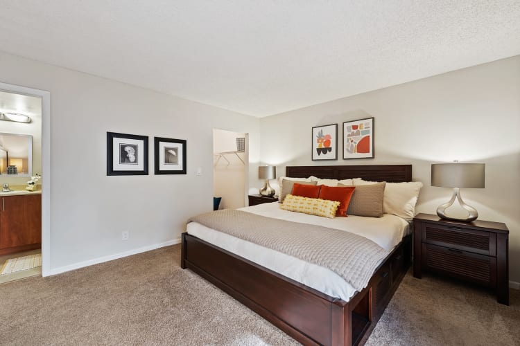 Large model bed with walk in closet and private bathroom at New Barn Apartments in Miami Lakes, Florida