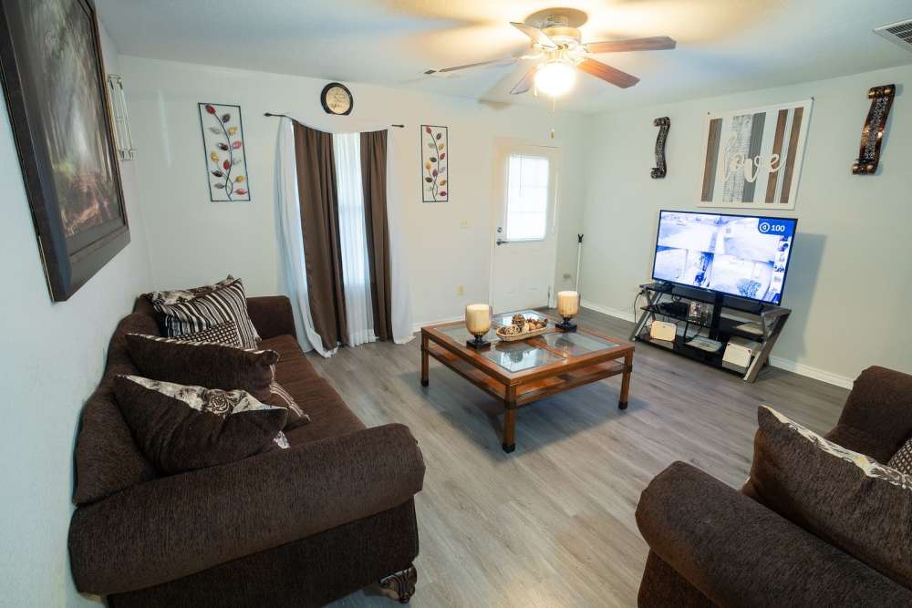 Living room with couch and tv at Bolivar Homes in Cleveland,Mississippi