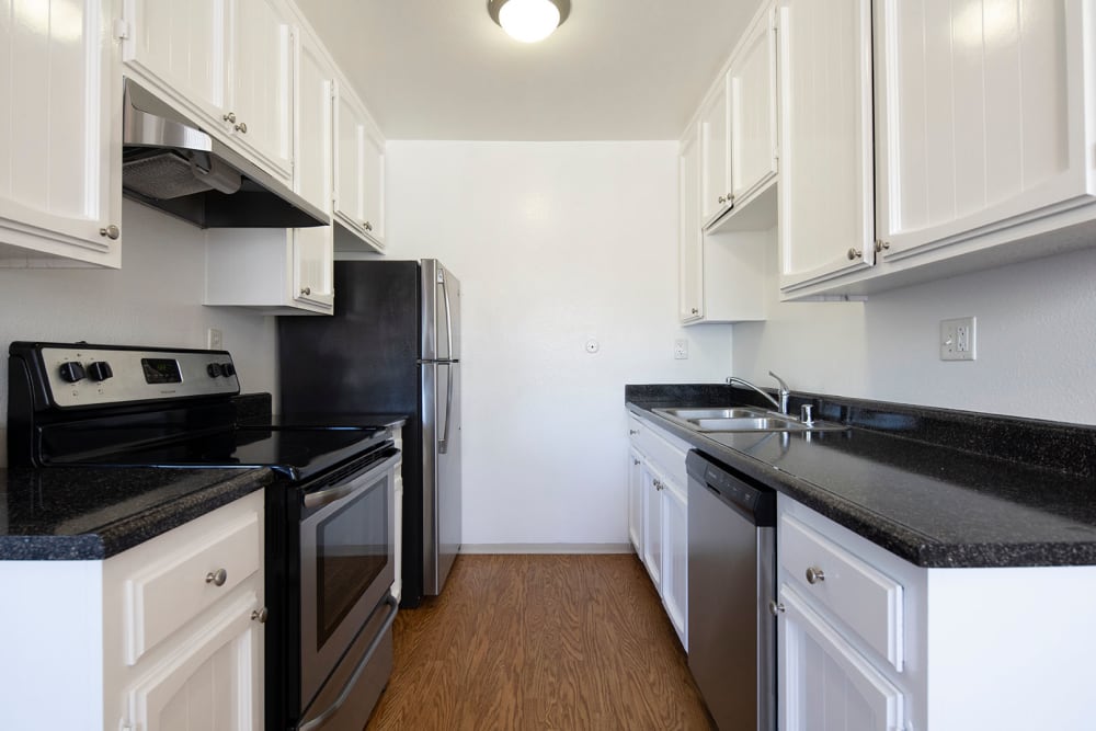 Kitchen area with modern appliances at Royal Village Apartments in San Diego, California