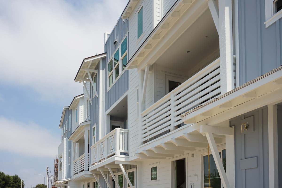 Exterior view of Whitewater homes with balconies at Tower24 Ponto Beach in Carlsbad, California