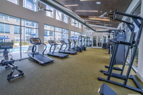 Fitness center with double height ceiling at Avonlea Pointe in Duluth, Georgia