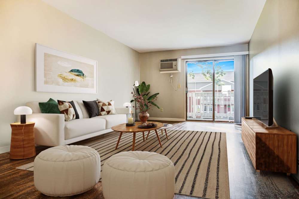 Living room with access to patio at Powdermill Village in Westfield, Massachusetts