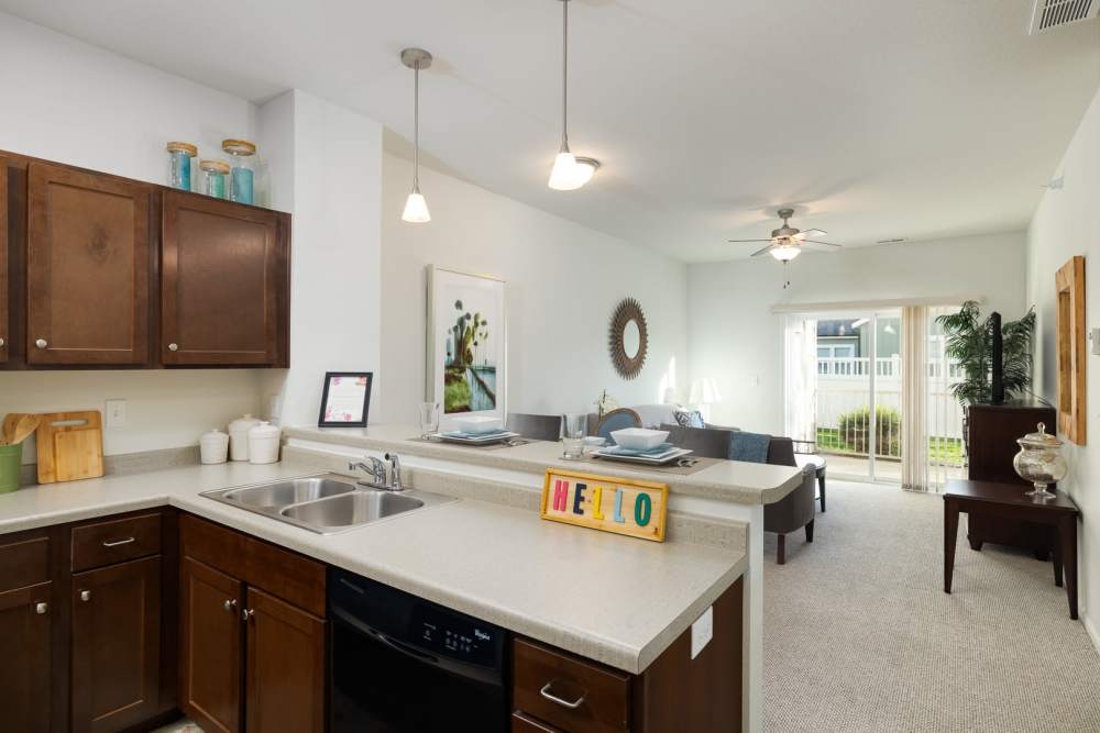 View of living room from kitchen in a model apartment at Regency Apartment Homes in Williston, North Dakota