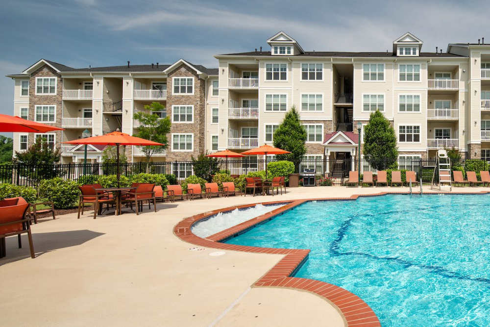 View of apartments with swimming pool at The Elms at Clarksburg Village in Clarksburg, Maryland