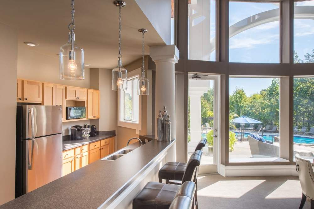 A wide angle of open kitchen with lots of lighting at The Elms at Falls Run in Ellicott City, Maryland