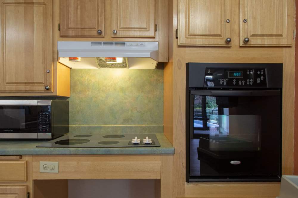 Microwave and oven in kitchen cabinetry at Victory Gardens in East Boston, Massachusetts