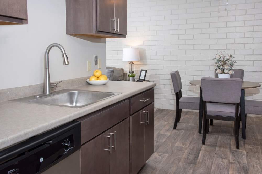 Kitchen sink with dining area at Meadowview Apartments in Anoka, Minnesota