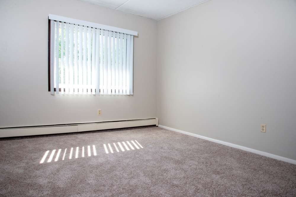 A bedroom with natural light pouring in at Meadowview Apartments in Anoka, Minnesota