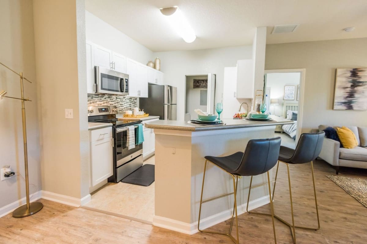 An apartment kitchen with bar seating at Citrus Tower in Clermont, Florida