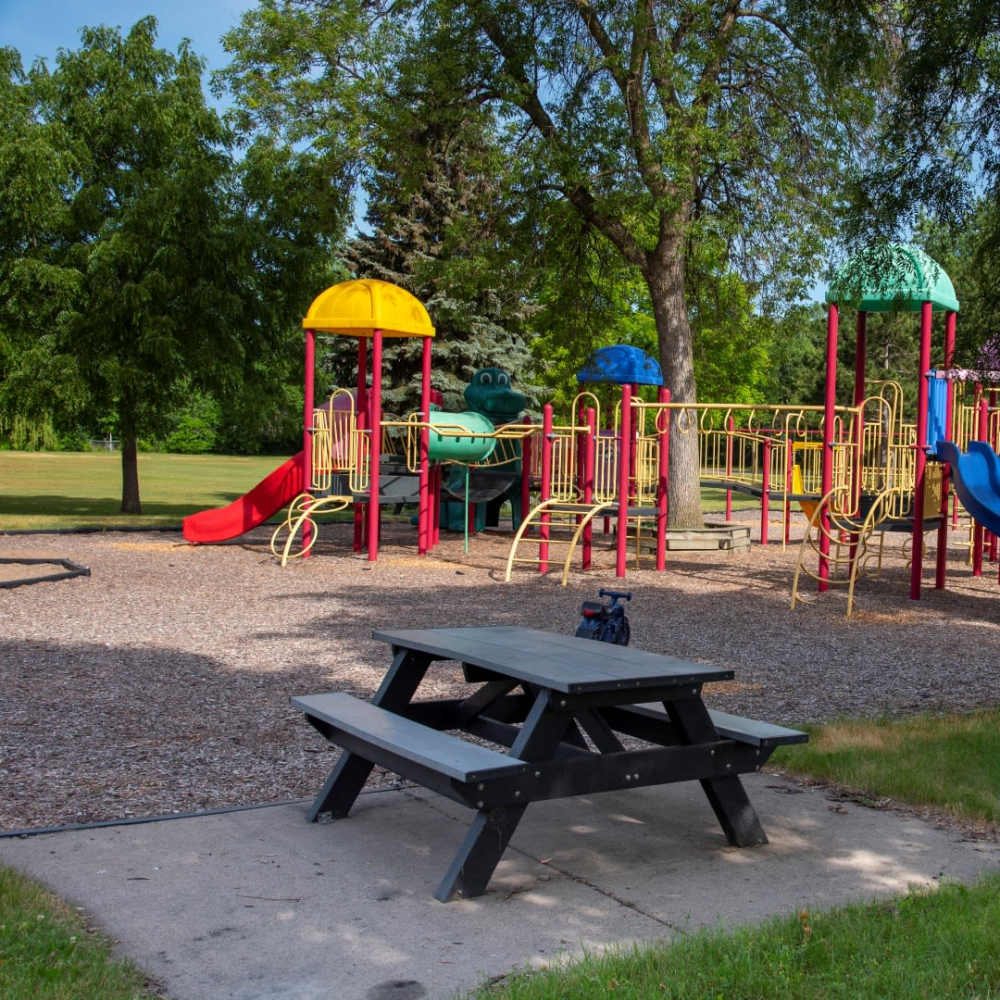 Childrens play area with various slides near Bass Lake Crossing in New Hope, Minnesota