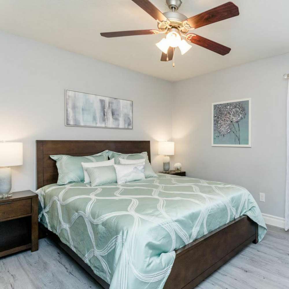 Cozy bedroom with a large bed and ceiling fan at Ridge Point in Houston, Texas