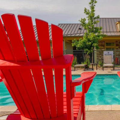 Bright red lounge chairs on the pool deck at Anatole on MacArthur in Oklahoma City, Oklahoma
