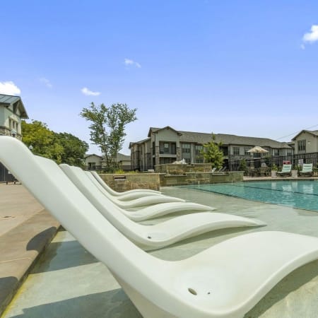 Lounge chairs in the pool at Auberge of Tyler in Tyler, Texas