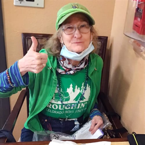 Smiling resident giving a thumbs up at Oxford Glen Memory Care at Grand Prairie in Grand Prairie, Texas