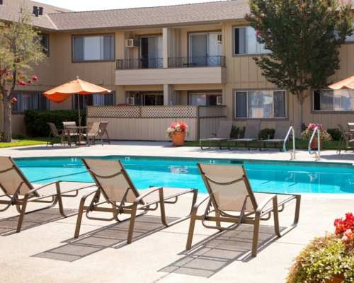 Swimming pool with patio and lounge chairs at Maplewood Apartment Homes, Mountain View, California