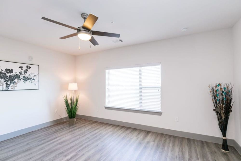 Spacious room with hardwood style flooring and ceiling fan at Argon in Oklahoma City, Oklahoma