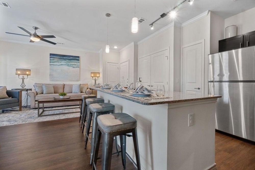 Open floor plan kitchen and living room at Auberge of Burleson in Burleson, Texas