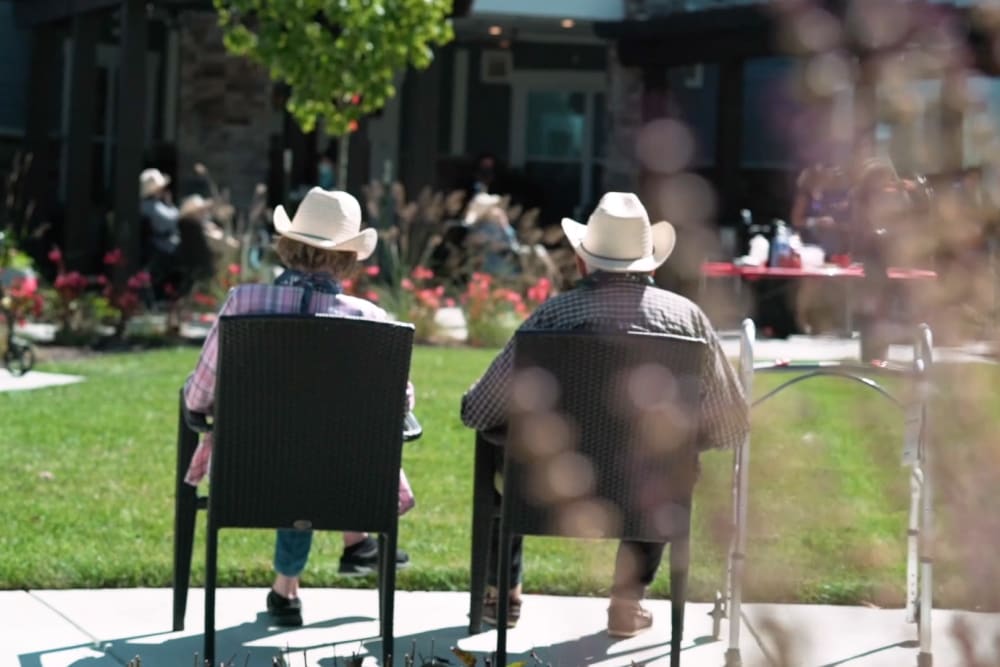 Two residents sitting outside at a Anthology Senior Living location