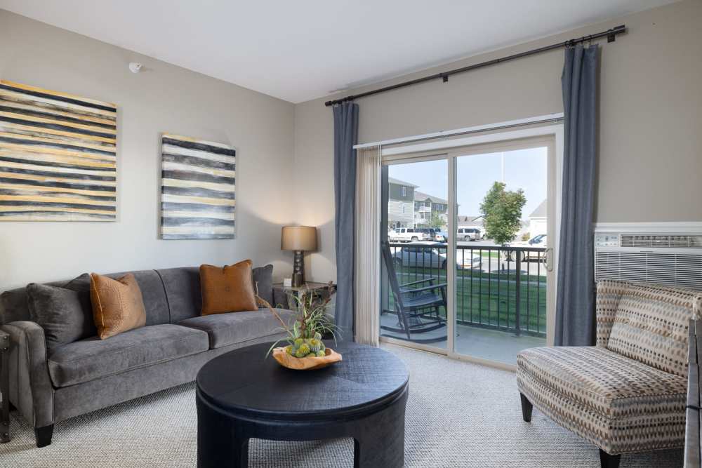 Living room with private balcony attached at University Commons in Williston, North Dakota