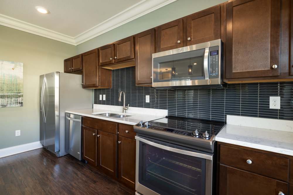 Kitchen with dark cabinetry at University Commons in Williston, North Dakota