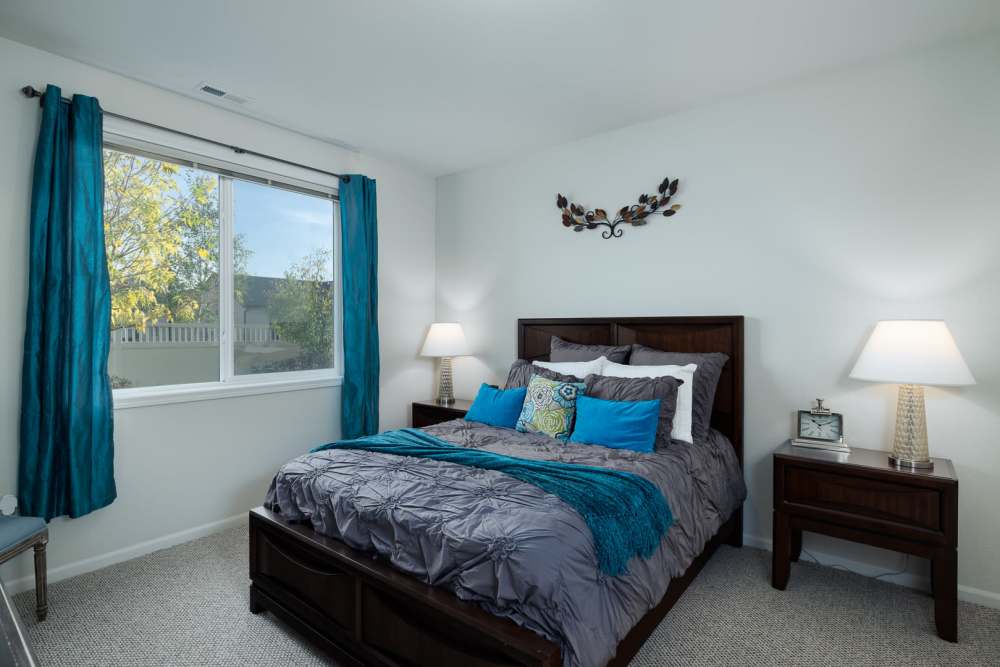 Modern furnishings in a model apartment's primary bedroom at Regency Apartment Homes in Williston, North Dakota