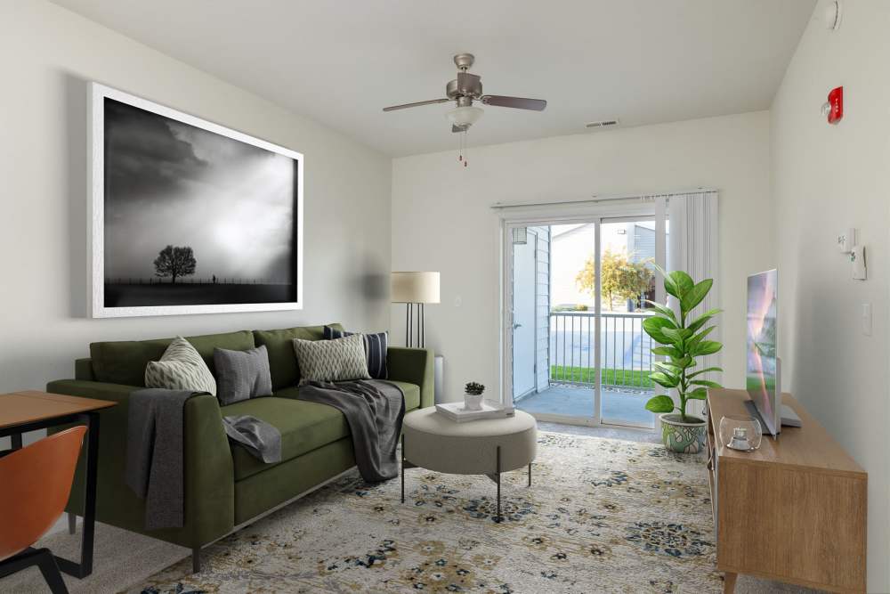 Cozy living room with balcony access at Regency Apartment Homes in Williston, North Dakota