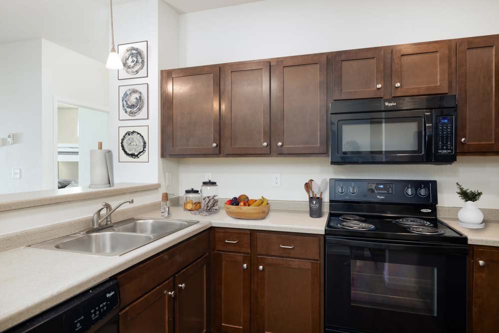 Kitchen with wooden cupboards at Regency Apartment Homes in Williston, North Dakota