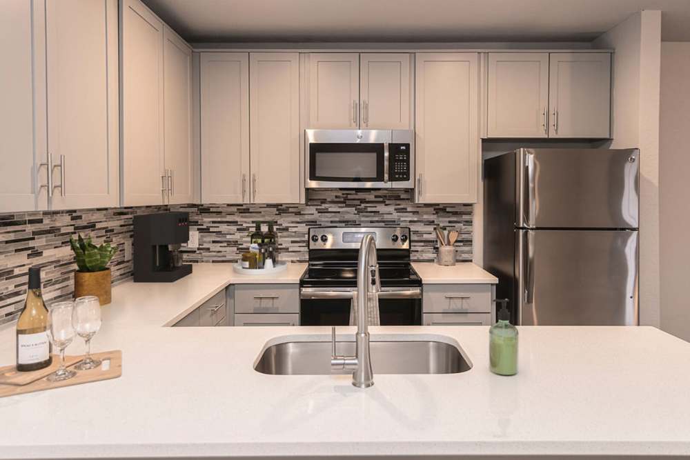 Kitchen with refrigerator at Slate at Cole in Dallas, Texas
