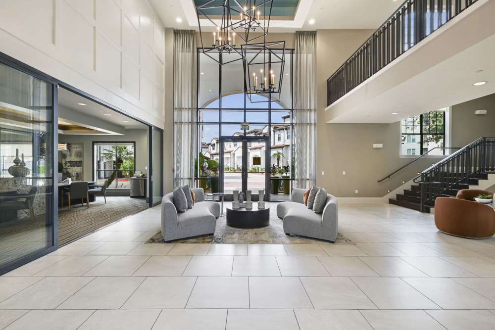 Lobby area with double height ceiling and glass entry door at Domain Memorial in Houston, Texas