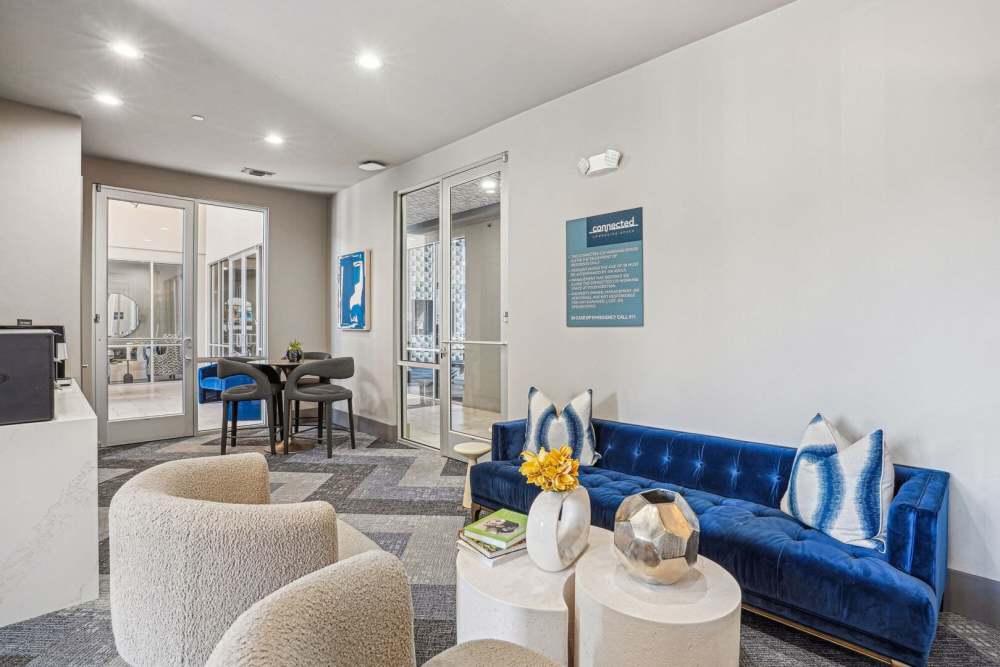 Clubhouse with couch, chairs, coffee table and carpet flooring at Kade in Dallas, Texas