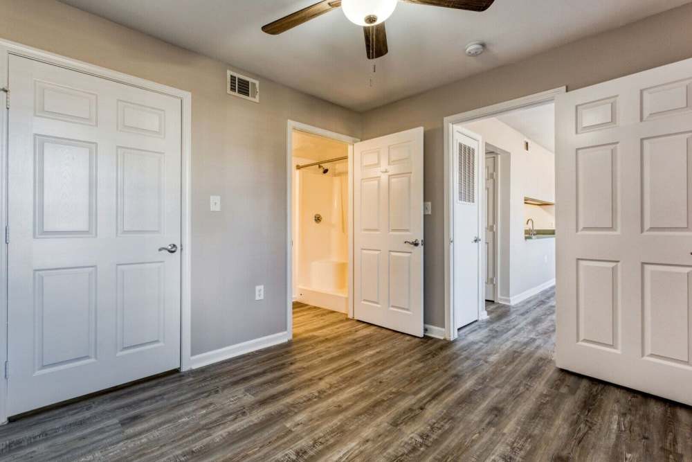 Unfurnished bedroom with closet and wooden flooring at Boomer Creek Apartments in Stillwater, Oklahoma