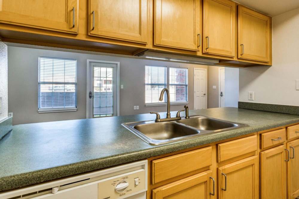 Apartment kitchen with white appliances at Boomer Creek Apartments in Stillwater, Oklahoma