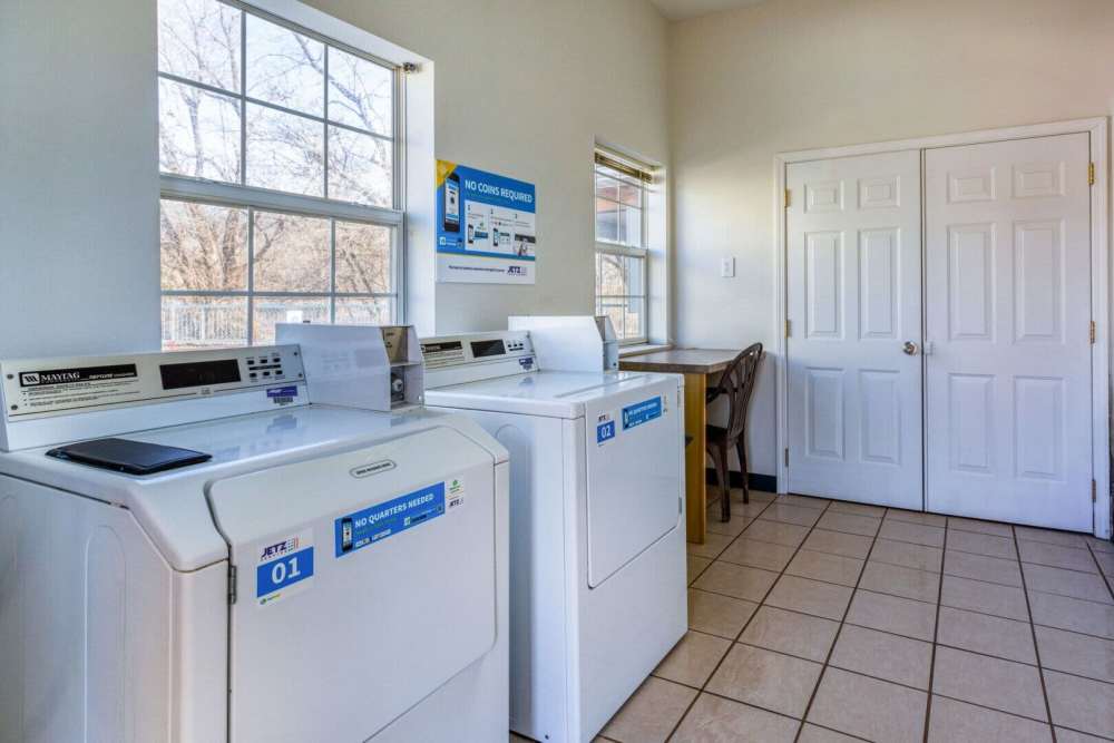 Community laundry room with washer and dryer at Boomer Creek Apartments in Stillwater, Oklahoma