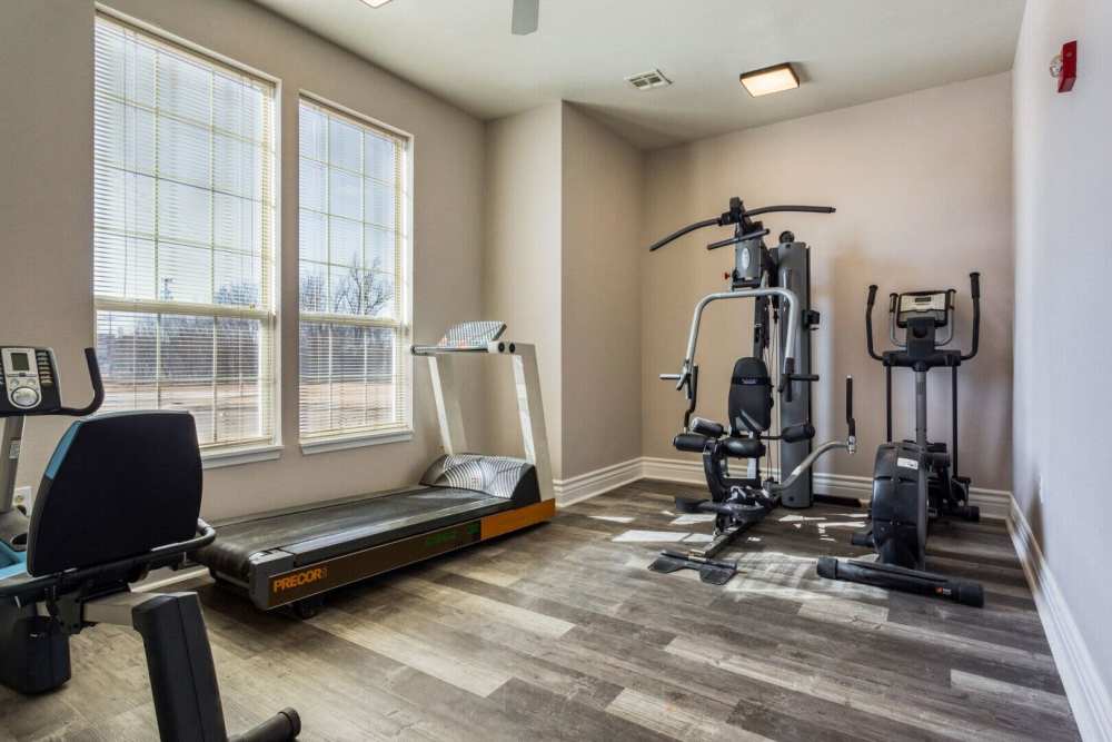 Fitness center with various equipment at Boomer Creek Apartments in Stillwater, Oklahoma