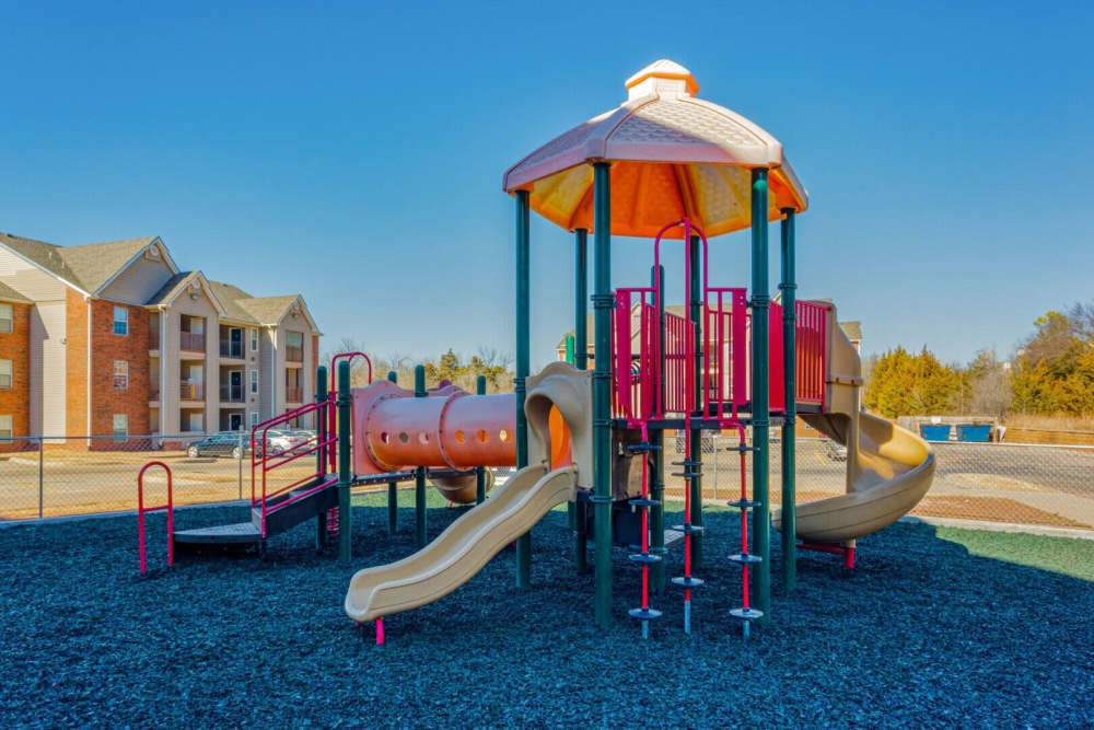 Kids Playground with slide at Boomer Creek Apartments in Stillwater, Oklahoma