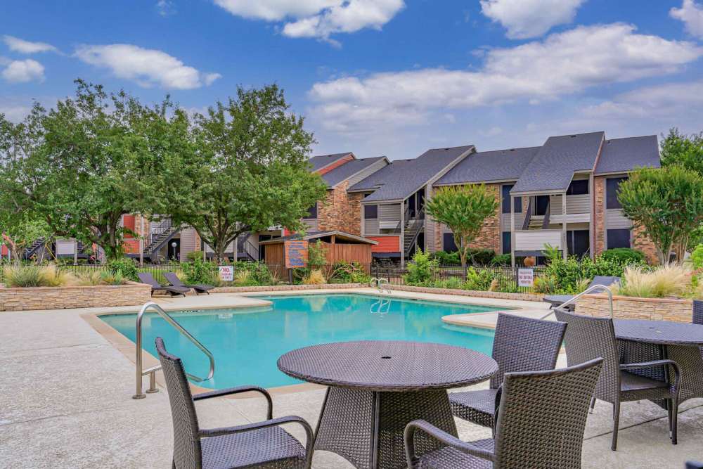 Stylish swimming pool with seating at Stoneridge in Kilgore, Texas