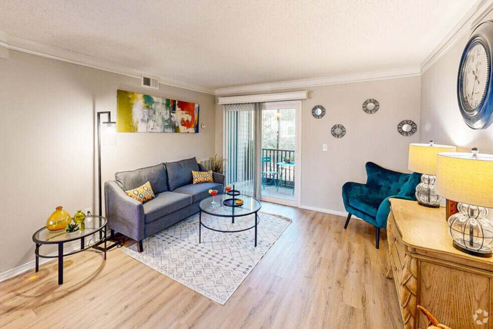Thoughtfully designed living room with yard access and plenty of natural light at Crickentree in Mt Pleasant, South Carolina,