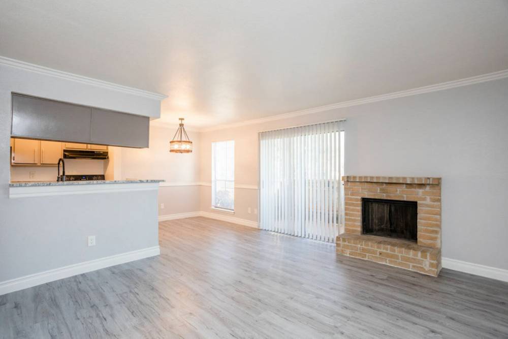 Combined view of fireplace and way to private balcony at Ridge Point in Houston, Texas