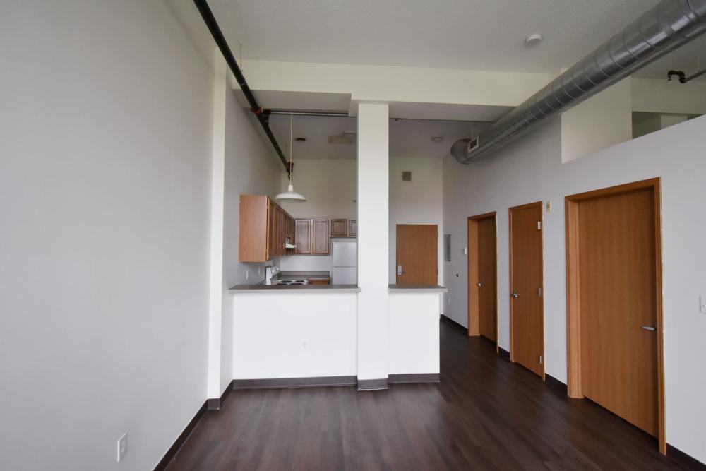 Kitchen area with wooden cabinets and appliances at Straus Lofts in Saint Paul, Minnesota
